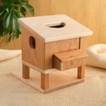 Wooden hen house with round hole on top and side ramp steps