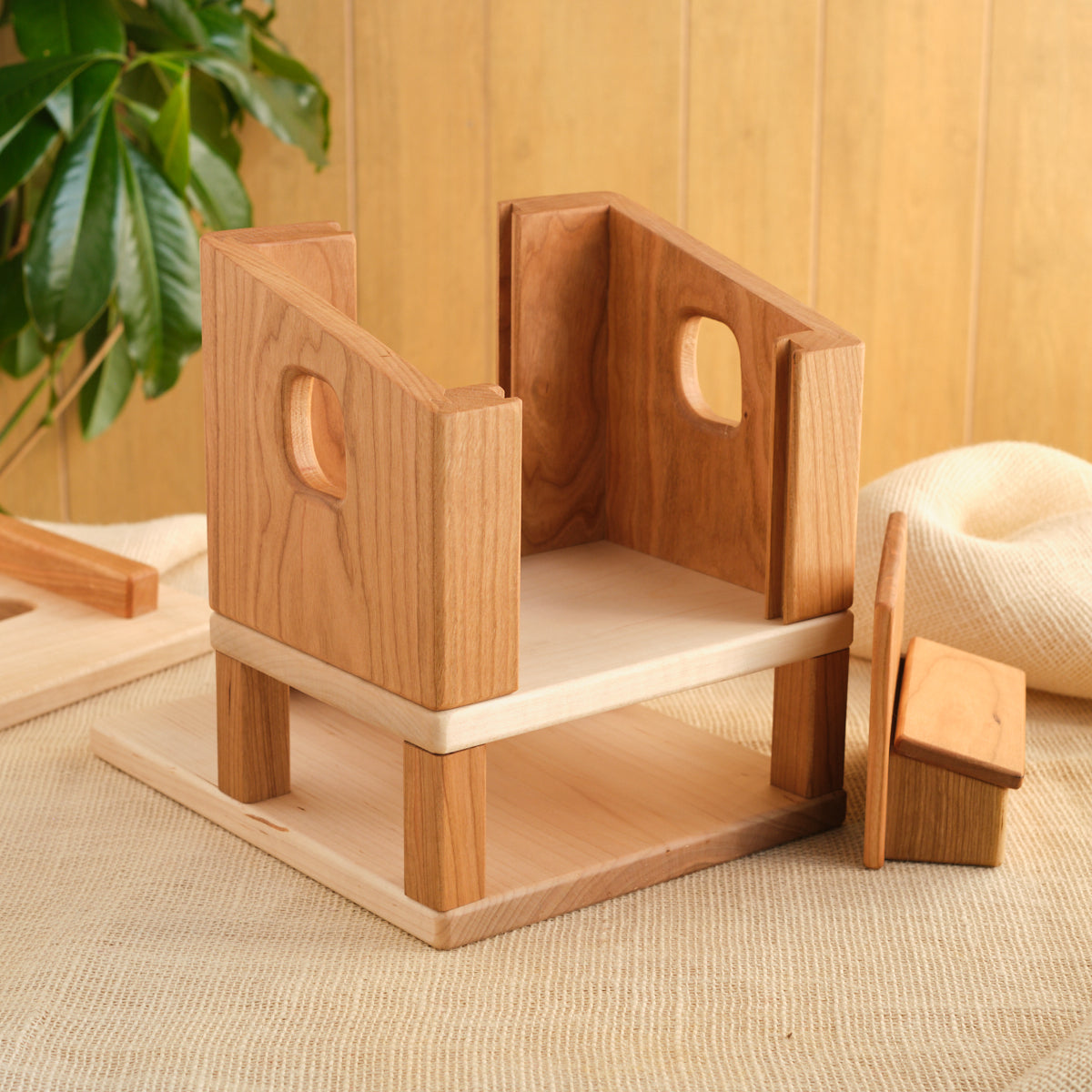 Wooden hen house with open front panels and stacked interior platforms