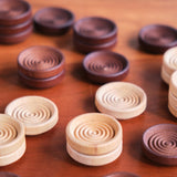 Stacking Wooden Checkers in a Muslin Bag