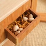 Wooden hen house with open tray holding eggs and straw bedding