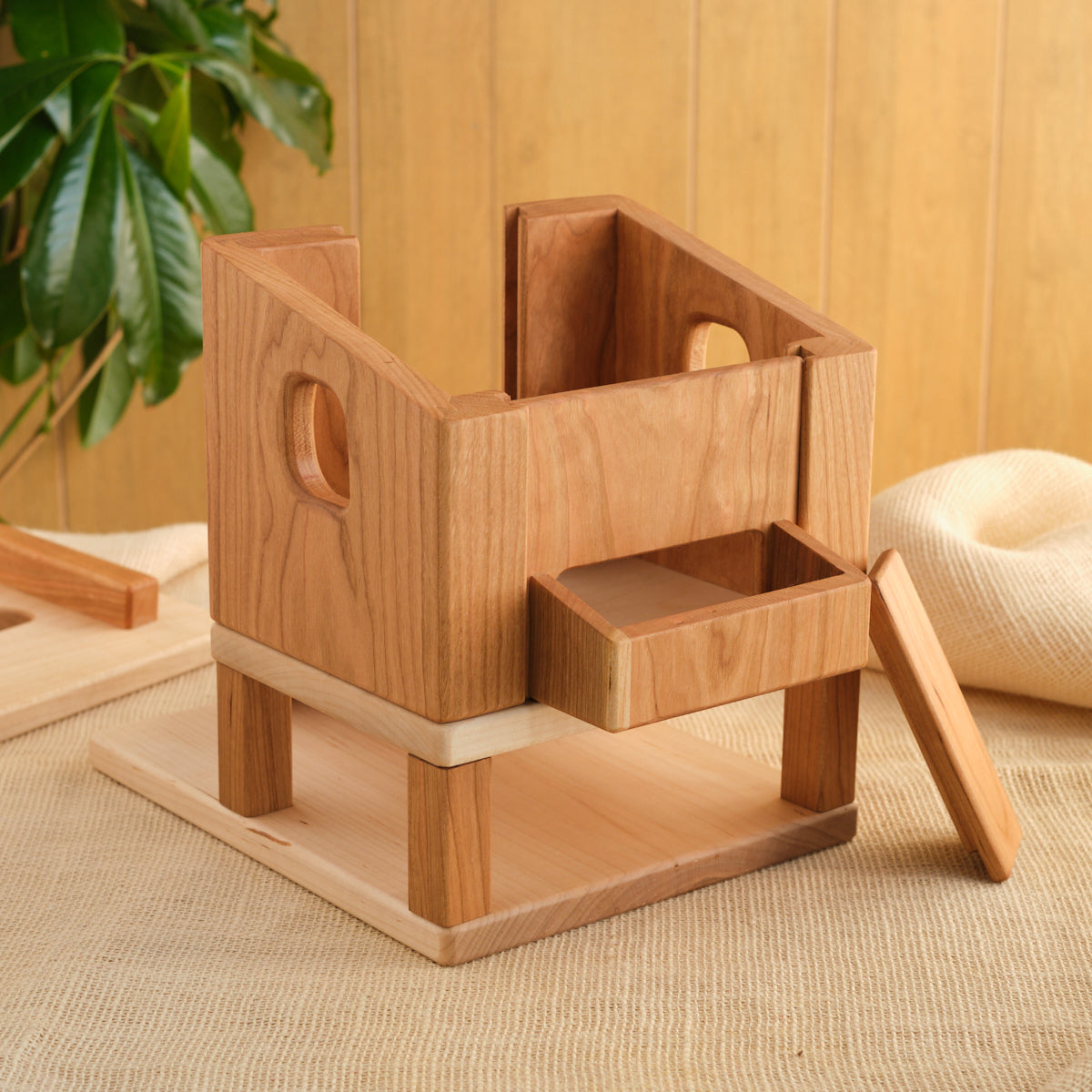 Wooden hen house with open doorway, two-level base, and ramp leading inside