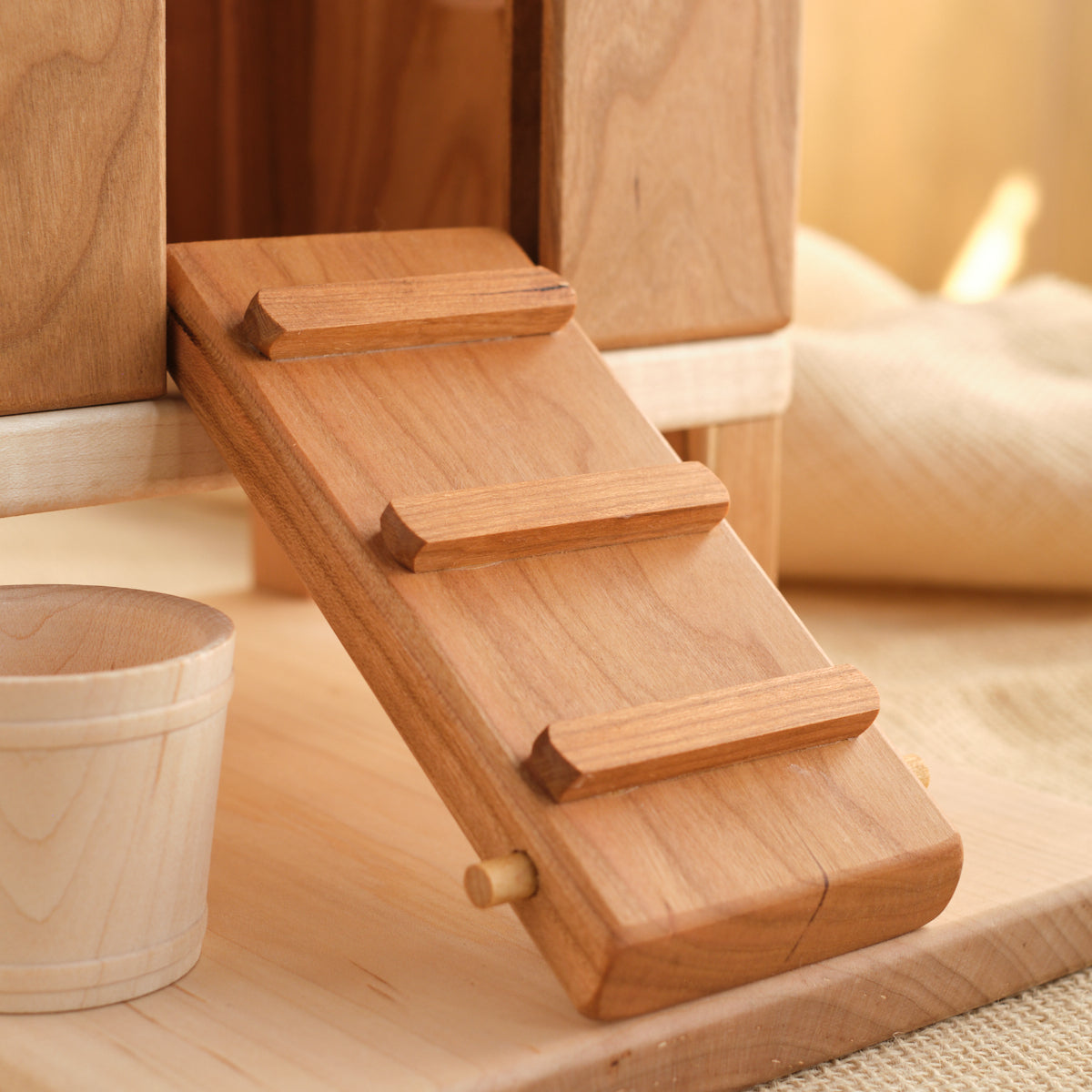 Wooden ramp steps on hen house base, close-up view