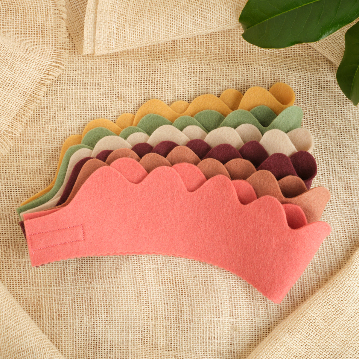 Set of 6 felt crowns in coral, tan, green, and burgundy, scalloped edges