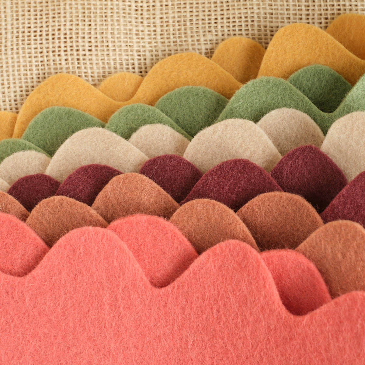Set of 6 felt crowns with tan, orange, green, and red tones, scalloped top