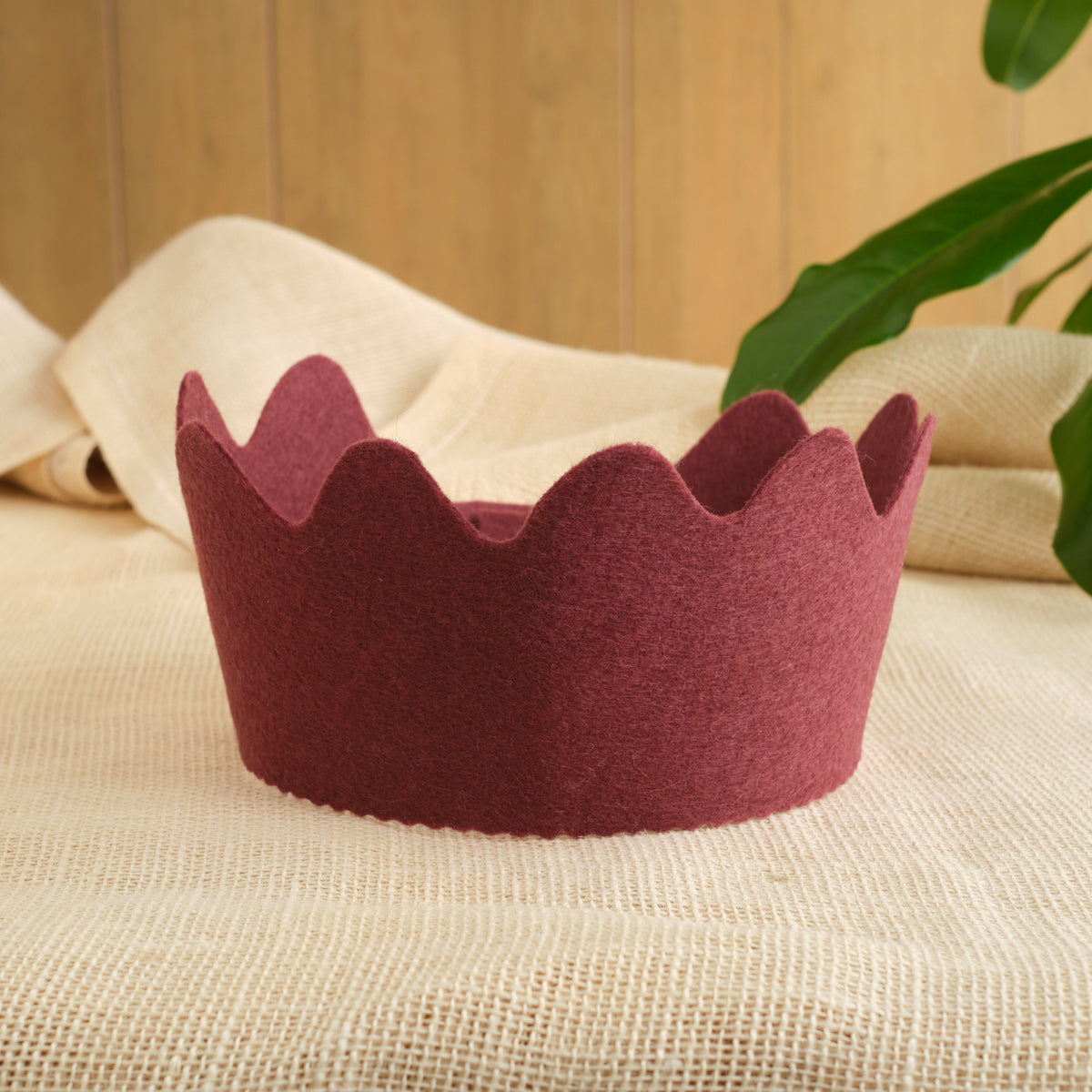 Felt crown with burgundy color, scalloped crown points, sturdy wool felt