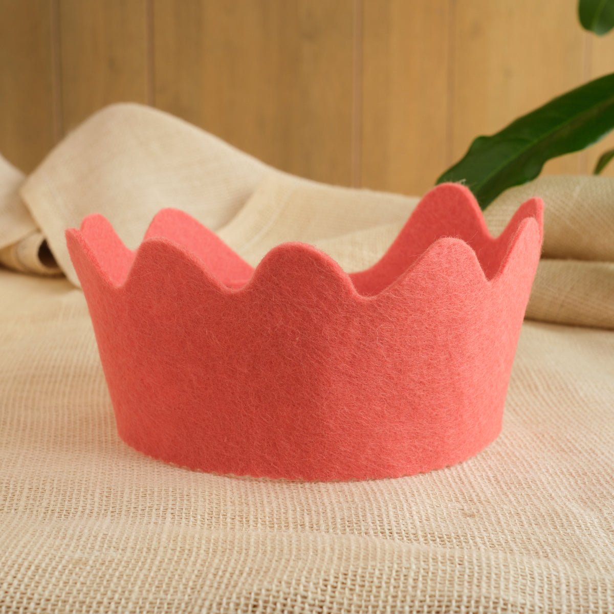 Felt crown in coral pink with scalloped crown points, wool felt design