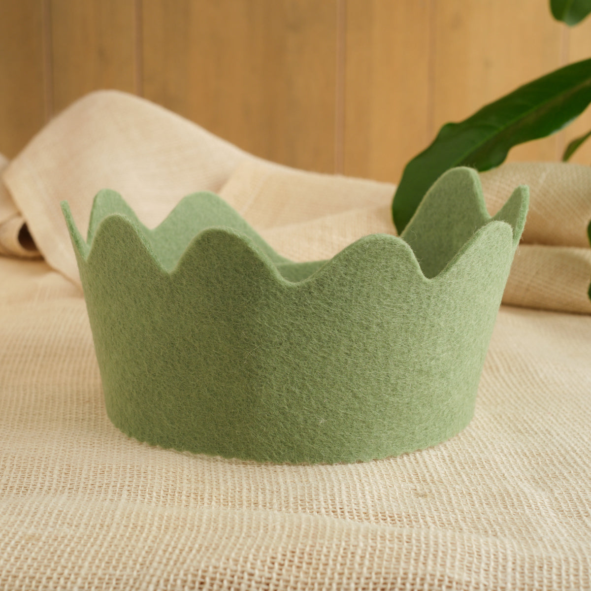 Felt crown in sage green with scalloped crown points, wool felt