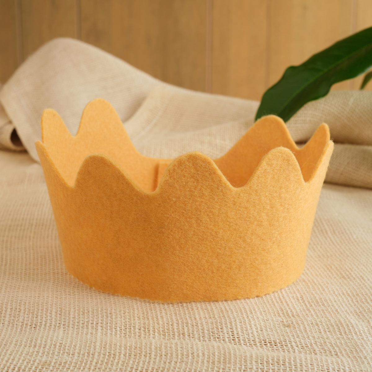 Felt crown in golden yellow with scalloped crown points, wool felt