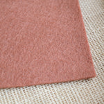 Rose wool felt sheet with soft textured surface, shown at an angle.
